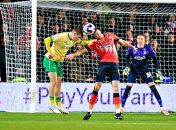 Reece Burke heads the ball clear