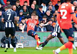 Alfie Doughty winces as he plays the ball