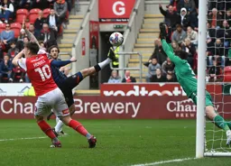 Luke Berry goes for the ball as Josh Vickers goes for the block