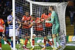 Carlton Morris carries the ball out of the net after scoring the Town`s goak