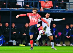Tom Lockyer and Cameron Archer go for the ball