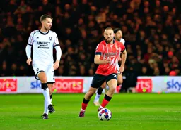 Allan Campbell runs with the ball away from Dan Barlaser