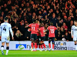 Carlton Morris is mobbed by some team mates after scoring the Town`s second goal