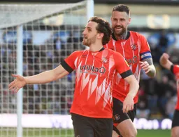 Tom Lockyer and Sonny Bradley celebrate Tom`s goal in front of the Hatters fans