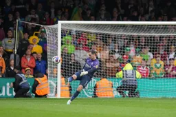 James Shea clears the ball downfield in front of City fans in fancy dress