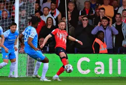 Jordan Clark controls the ball with his back to the goal
