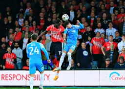 Elijah Adebayo heads the ball on