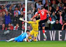 Carlton Morris shoots from close range as Anthony Patterson spreads himself