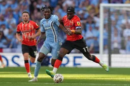 Pelly Ruddock-Mpanzu competes for the ball against Brooke Norton -Cuffy