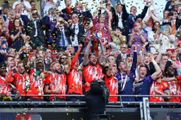 Sonny Bradley preforms his last duty as club captain in lifting the trophy