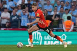 Reece Burke strides forward with the ball