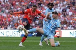 Carlton Morris' attempt at goal is blocked by Luke McNally