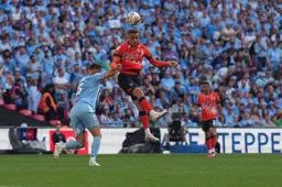 Carlton Morris rises above Kyle McFadzean