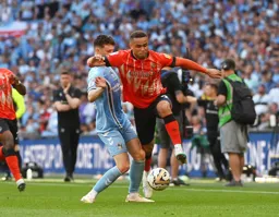 Carlton Morris skips past his man