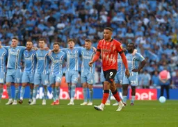 Carlton Morris takes the long walk before taking the first penalty