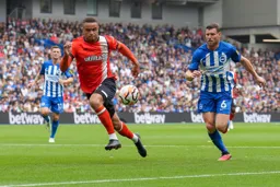 Carlton Morris takes on Albion’s James Milner