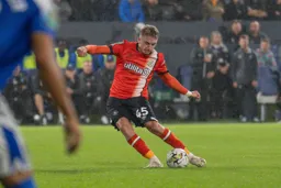 Alfie Doughty sends a curling shot from outside the box for Town’s second