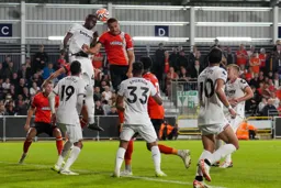 Carlton Morris up in a challenge with the Hammers defender Kurt Zouma
