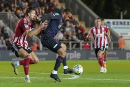 Carlton Morris holding off the defender