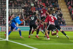 Jacob Brown tries to take the Exeter keepers shirt