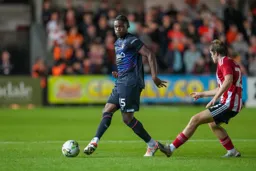 Teden Mengi passing out of defence