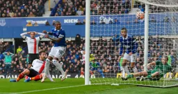 Tom Lockyer watches his effort end up in the Everton net