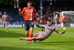 Carlton Morris about to be taken down by Argentinian Cristian Romero