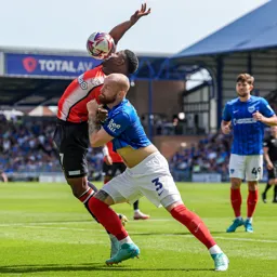 Connor Ogilvie gives Chiedozie Ogbene a shove