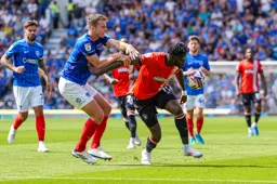 Elijah Adebayo is held as he goes for the ball
