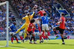 Will Norris punches the ball away from Elijah Adebayo`s head