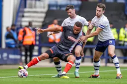 Carlton Morris comes under pressure from Ben Whiteman