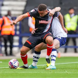 Carlton Morris holds off his marker