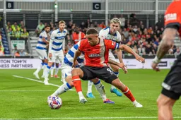 Carlton Morris holds off a defender