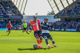 Elijah Adebayo holds Japhet Tanganga off the ball