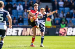 Reece Burke goes in with a raised boot
