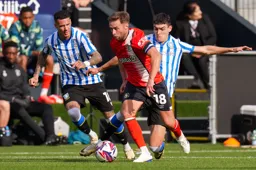 Jordan Clark moves away from two defenders