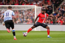 Teden Mengi stretches to reach the ball