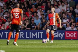 Mark McGuinness plays a pass to Marvelous Nakamba
