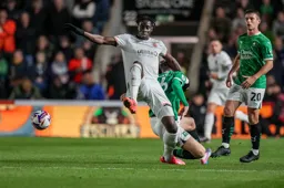 Elijah Adebayo beats Kornel Szucs to the ball