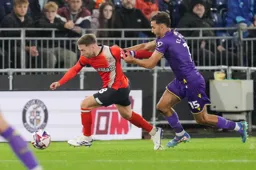 Jordan Clark wrestles for the ball with Idris El Mizouni