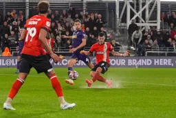 Tom Krauss kicks up some spray as he scores the Town`s second goal