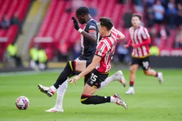 Elijah Adebayo is on the receiving end of a robust challenge by Anel Ahmedhodzic