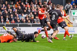 A scramble in front of the Watford goal with Tom Holmes in the thick of it