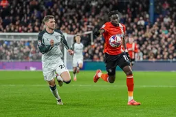 Elijah Adebayo chases the ball with Chris Mepham in hot pursuit