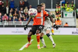 Elijah Adebayo watches the ball come towards him