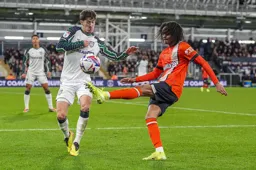 Tahith Chong attempts to lift the ball over Trai Hume