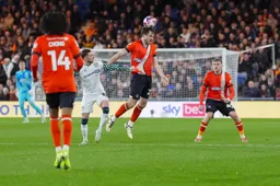 Tom Holmes wins a header despite Alan Browne grabbing his shirt