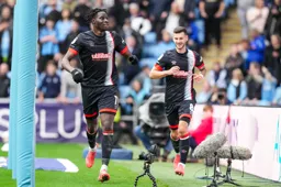Elijah Adebayo goes to celebrate with the travelling support after scoring the second goal