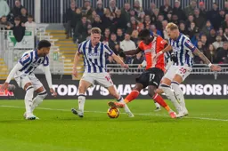 Elijah Adebayo takes on three defenders