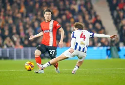 Daiki Hashioka avoids Callum Styles out stretched leg